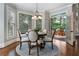 Cozy breakfast nook with a round table, four chairs, and natural light through the windows at 10135 High Falls Pointe, Johns Creek, GA 30022