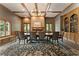 Formal dining room featuring a large table, fireplace, and built-in shelving at 10135 High Falls Pointe, Johns Creek, GA 30022