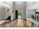 Bright foyer with hardwood floors and a view to the open front door and dining room at 10135 High Falls Pointe, Johns Creek, GA 30022