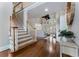 Grand foyer featuring a staircase, hardwood floors, and a view into the living room at 10135 High Falls Pointe, Johns Creek, GA 30022