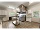 Commercial kitchen with stainless steel appliances, large vent hood and ample counter space at 10135 High Falls Pointe, Johns Creek, GA 30022