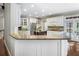 Well-lit kitchen with granite countertops, stainless steel appliances, and custom white cabinets at 10135 High Falls Pointe, Johns Creek, GA 30022