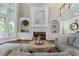 Bright living room with large windows, built-in shelves, fireplace and comfortable seating at 10135 High Falls Pointe, Johns Creek, GA 30022