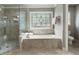 Main bathroom features a jetted tub beneath a stained glass window, and a glass enclosed shower at 10135 High Falls Pointe, Johns Creek, GA 30022