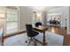 Bright office with large windows, wood desk, and comfortable chair, bathed in natural light at 10135 High Falls Pointe, Johns Creek, GA 30022