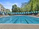 Enjoy this outdoor pool with lap lanes, lifeguard stand and blue and green pennant decorations at 10135 High Falls Pointe, Johns Creek, GA 30022