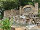 Beautiful water feature with stone detail and community signage at The Falls of Autry Mill at 10135 High Falls Pointe, Johns Creek, GA 30022