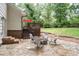 Stone patio with outdoor seating and fire pit for entertaining in the backyard at 2786 Georgian Ter, Marietta, GA 30068