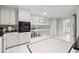 Spacious kitchen with white cabinets, black countertops, stainless appliances, and access to other living spaces at 2786 Georgian Ter, Marietta, GA 30068