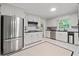 Spacious kitchen with stainless steel appliances, white cabinets, granite countertops, and tile flooring at 2786 Georgian Ter, Marietta, GA 30068