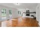 Bright living room with hardwood floors, white brick fireplace, and French doors to the backyard at 2786 Georgian Ter, Marietta, GA 30068