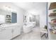 Bright bathroom with dual vanities, soaking tub, walk-in shower, and stylish decor elements at 410 Concord St, Alpharetta, GA 30009