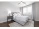 Stylish bedroom showcasing a comfortable bed, gray accents, dark hardwood floors, and bright natural light at 410 Concord St, Alpharetta, GA 30009