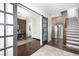 Inviting entryway featuring dark hardwood floors, a sliding barn door, and exposed brick at 410 Concord St, Alpharetta, GA 30009