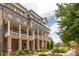 Beautiful townhome with brick and siding, a covered porch, a balcony, and mature landscaping at 410 Concord St, Alpharetta, GA 30009