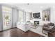 Bright and inviting living room with hardwood floors, modern decor, and access to a balcony at 410 Concord St, Alpharetta, GA 30009