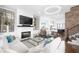 Stylish living room with a fireplace, hardwood floors, modern decor, and plenty of natural light at 410 Concord St, Alpharetta, GA 30009