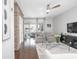 Bright living room featuring a modern ceiling fan, brick accent wall, and glass doors to a patio at 410 Concord St, Alpharetta, GA 30009