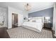 Spacious main bedroom features a stylish area rug, an accent wall, and an ensuite bathroom at 410 Concord St, Alpharetta, GA 30009