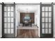 Well-lit home office with hardwood floors, a feature wall, and glass sliding doors at 410 Concord St, Alpharetta, GA 30009