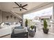 Inviting outdoor patio featuring a white couch, outdoor seating, and a decorative ceiling fan at 410 Concord St, Alpharetta, GA 30009