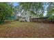 Wide backyard view with a patio set, grill, and a wooden fence enclosing the property at 5461 Forest Path Ct, Stone Mountain, GA 30088
