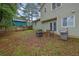 View of a lush backyard with a patio, grill, and fenced perimeter at 5461 Forest Path Ct, Stone Mountain, GA 30088