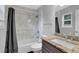 Bathroom features granite countertops, a tub-shower combo with marble tile, and dark wood-look flooring at 5461 Forest Path Ct, Stone Mountain, GA 30088