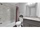 Bathroom featuring granite countertops, a tub-shower combo with marble tile, and dark wood-look flooring at 5461 Forest Path Ct, Stone Mountain, GA 30088