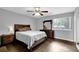 Relaxing bedroom features wood-look flooring, a queen-sized bed, a dresser with a mirror and a nightstand at 5461 Forest Path Ct, Stone Mountain, GA 30088