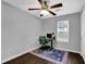 A well-lit bedroom with a ceiling fan, a desk, and a colorful rug on top of the hardwood flooring at 5461 Forest Path Ct, Stone Mountain, GA 30088