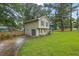Well-maintained home featuring a convenient garage and complemented by a lush lawn and landscaping at 5461 Forest Path Ct, Stone Mountain, GA 30088