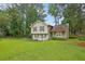 Well-maintained home on a lush lawn featuring mature trees, complemented by charming landscaping at 5461 Forest Path Ct, Stone Mountain, GA 30088