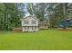 Charming home with a well-manicured lawn, complemented by lush trees and lovely landscaping at 5461 Forest Path Ct, Stone Mountain, GA 30088