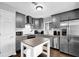 Well-lit kitchen boasts stainless steel appliances, white subway tile backsplash, and an island with countertop at 5461 Forest Path Ct, Stone Mountain, GA 30088