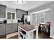 Bright eat-in kitchen featuring gray cabinets, stainless steel appliances, an island and a dining table with seating at 5461 Forest Path Ct, Stone Mountain, GA 30088