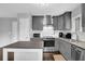 Stylish kitchen with stainless steel appliances, gray cabinets, and a kitchen island topped with granite countertop at 5461 Forest Path Ct, Stone Mountain, GA 30088