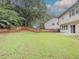 Large backyard featuring expansive lawn and a wooden fence, perfect for outdoor activities at 750 Summerstone Ln, Lawrenceville, GA 30044