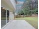 View of backyard featuring a concrete patio, wooden fence, and lush green grass at 750 Summerstone Ln, Lawrenceville, GA 30044