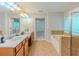 Bright bathroom featuring double sinks, bathtub and natural light from a window at 750 Summerstone Ln, Lawrenceville, GA 30044