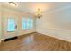Bright dining room featuring hardwood floors, wainscoting, and an elegant chandelier at 750 Summerstone Ln, Lawrenceville, GA 30044