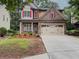 Charming two-story brick home featuring a two-car garage and well-maintained landscaping at 750 Summerstone Ln, Lawrenceville, GA 30044
