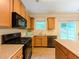 Well-lit kitchen features wooden cabinets, stainless steel appliances and an island with breakfast bar, great for everyday living at 750 Summerstone Ln, Lawrenceville, GA 30044
