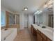 Large main bathroom with double sinks, soaking tub, a tiled shower, and a separate toilet room at 750 Summerstone Ln, Lawrenceville, GA 30044