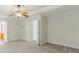 Large main bedroom featuring neutral paint, carpet, and a door leading to the ensuite bathroom at 750 Summerstone Ln, Lawrenceville, GA 30044