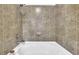 Bathroom shower and tub combo with neutral colored tile and brushed nickel hardware at 898 Oak Sw St # 3204, Atlanta, GA 30310