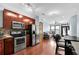 Modern kitchen featuring stainless steel appliances and rich wood cabinetry, seamlessly flowing into the living area at 898 Oak Sw St # 3204, Atlanta, GA 30310