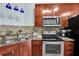 Featuring stainless steel appliances, granite countertops, and sleek wood cabinets with blue pendant lights above the sink at 898 Oak Sw St # 3204, Atlanta, GA 30310