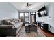 Comfortable living room features a plush gray sofa, modern ceiling fan, and TV, creating a relaxing entertainment space at 898 Oak Sw St # 3204, Atlanta, GA 30310