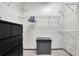 Walk-in closet with white wire shelving and a black dresser and storage container at 898 Oak Sw St # 3204, Atlanta, GA 30310